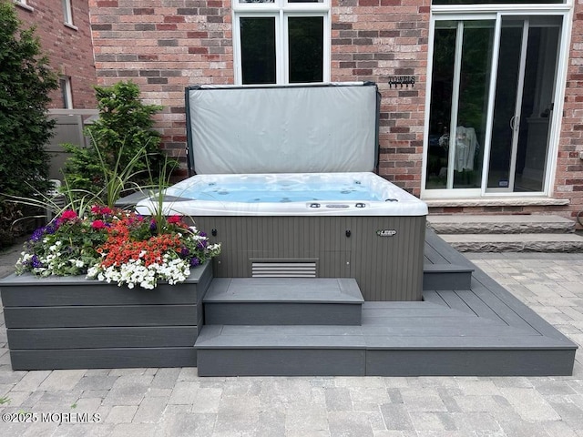 deck featuring entry steps and a hot tub