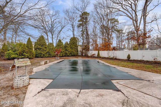 view of swimming pool featuring a fenced backyard and a patio
