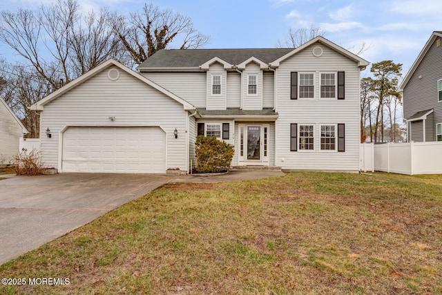 traditional-style home with a front lawn, fence, a garage, and concrete driveway