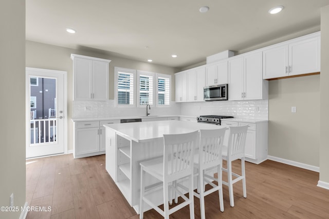 75 Driftwood Cir, Oceanport, NJ 07757 - kitchen with white cabinetry, stainless steel microwave, gas stove, and a sink