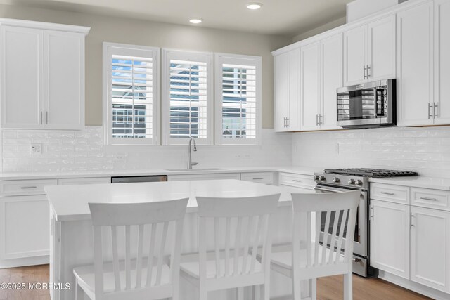 75 Driftwood Cir, Oceanport, NJ 07757 - kitchen featuring recessed lighting, a center island, a sink, appliances with stainless steel finishes, and backsplash