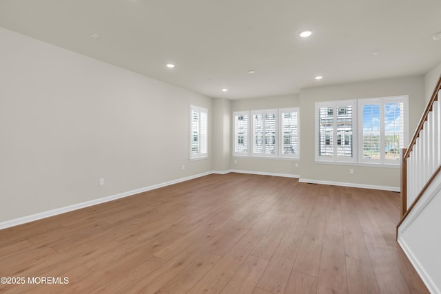 75 Driftwood Cir, Oceanport, NJ 07757 - unfurnished living room with stairway, baseboards, light wood-type flooring, and a wealth of natural light