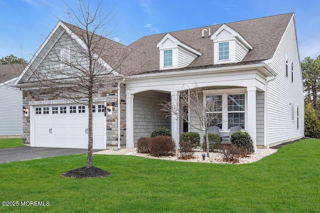 cape cod-style house featuring an attached garage, aphalt driveway, roof with shingles, and a front yard