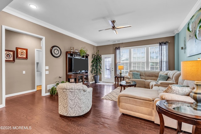 living room featuring ornamental molding, dark wood-type flooring, baseboards, and ceiling fan