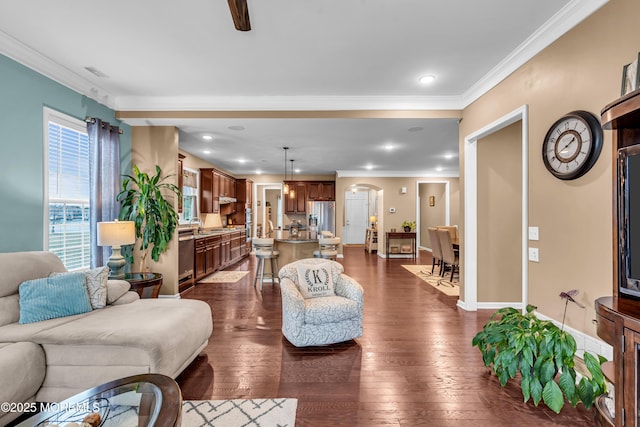 living area with ornamental molding, dark wood-style flooring, arched walkways, and visible vents