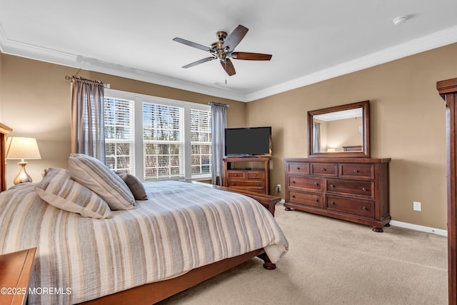 bedroom with a ceiling fan, ornamental molding, baseboards, and light carpet