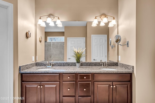 full bath featuring a stall shower, double vanity, a notable chandelier, and a sink