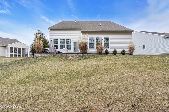 back of house featuring a sunroom and a yard
