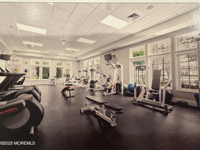 exercise room with visible vents and a drop ceiling