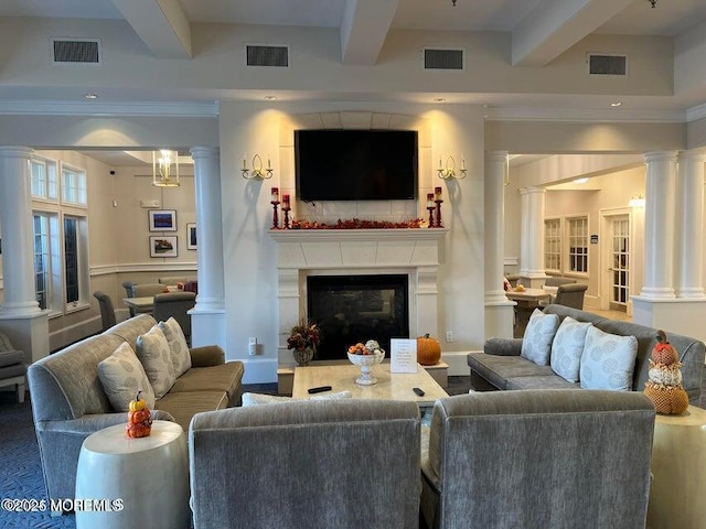 living room featuring visible vents, beamed ceiling, and ornate columns