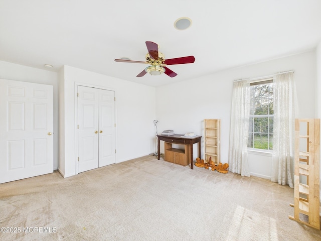 bedroom featuring a closet, a ceiling fan, carpet, and baseboards