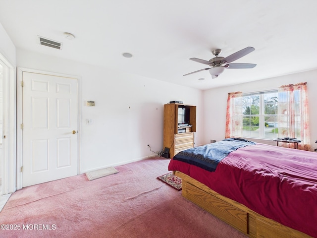 carpeted bedroom with visible vents, ceiling fan, and baseboards