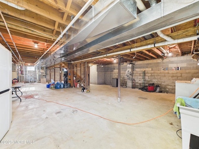 unfinished below grade area featuring washing machine and clothes dryer