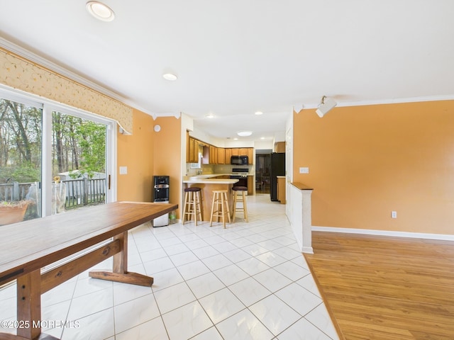 dining room featuring crown molding, recessed lighting, light tile patterned floors, and baseboards