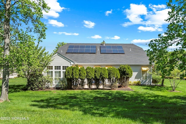1505 Wishing Well Ln, Manasquan, NJ 08736 - back of property featuring roof mounted solar panels, a yard, and a shingled roof