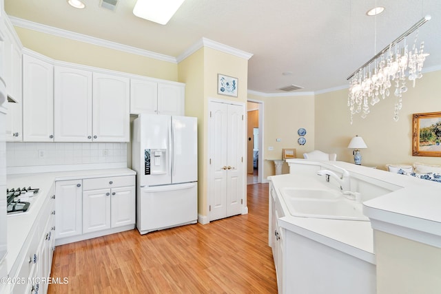 1505 Wishing Well Ln, Manasquan, NJ 08736 - kitchen with white appliances, crown molding, light wood-style floors, white cabinetry, and light countertops