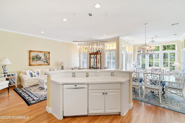 1505 Wishing Well Ln, Manasquan, NJ 08736 - kitchen featuring white dishwasher, a sink, a chandelier, open floor plan, and ornamental molding