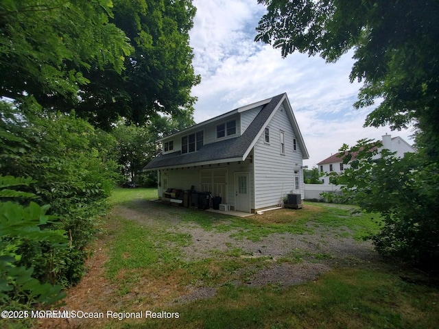 92 Compton St, Belford, NJ 07718 - view of side of home with central AC unit and roof with shingles