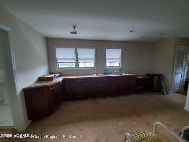 92 Compton St, Belford, NJ 07718 - kitchen with visible vents, light countertops, a sink, and dark brown cabinets