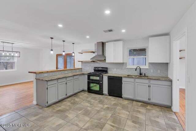 115 Leesville Rd, Jackson, NJ 08527 - kitchen featuring tasteful backsplash, a sink, wall chimney range hood, a peninsula, and black appliances
