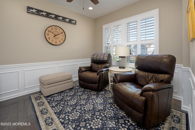 living area with a wainscoted wall, ceiling fan, wood finished floors, and recessed lighting