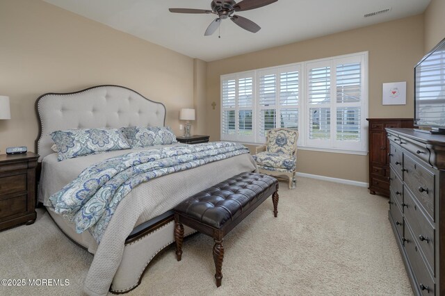 bedroom with light carpet, baseboards, visible vents, and ceiling fan