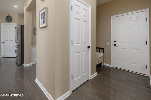 corridor with baseboards and dark wood-style flooring