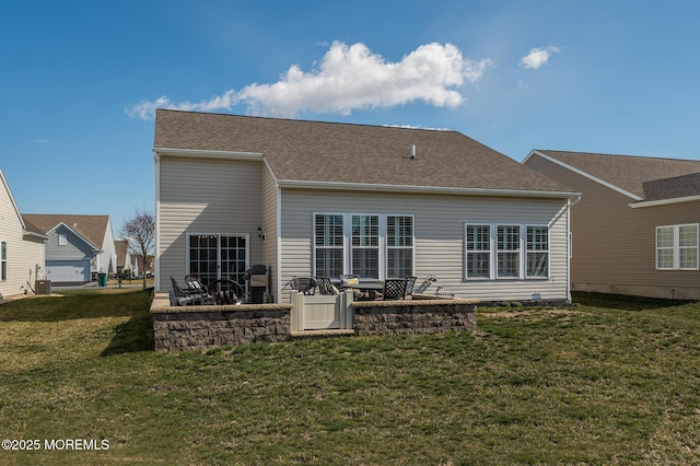 back of house with a patio area and a yard