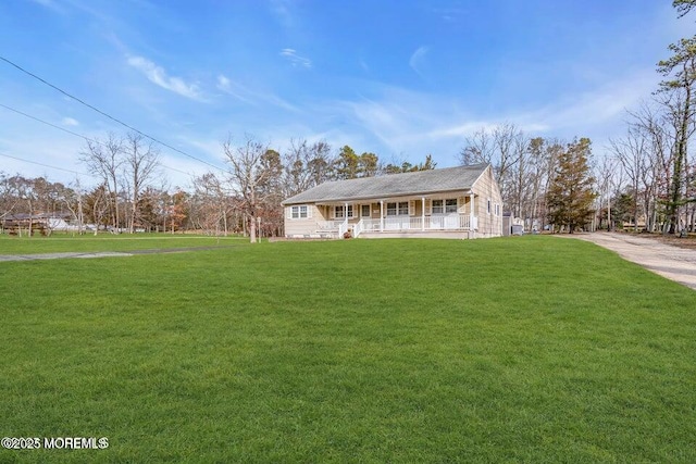 view of front facade with a front lawn and covered porch
