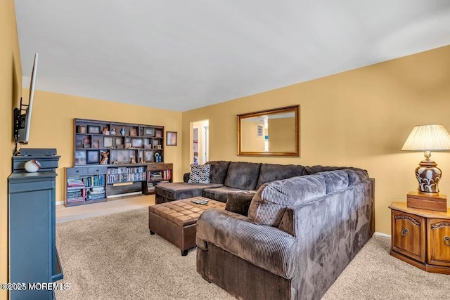 carpeted living area featuring baseboards