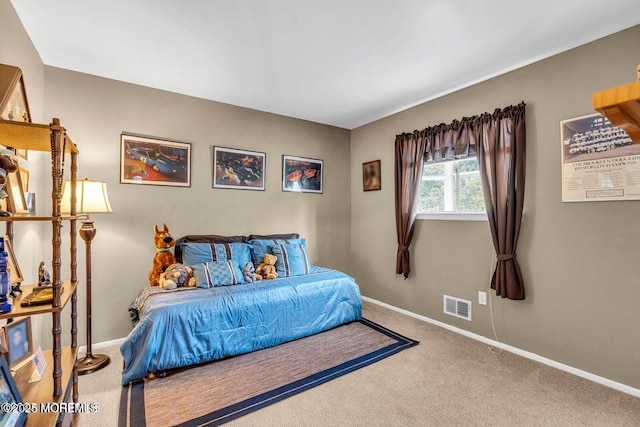 carpeted bedroom featuring baseboards and visible vents