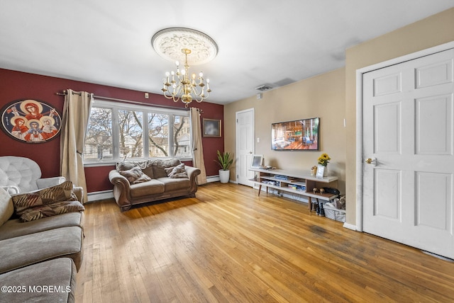 2776 John F Kennedy Blvd, Jersey City, NJ 07306 - living area with a baseboard radiator, baseboards, a baseboard heating unit, hardwood / wood-style floors, and an inviting chandelier