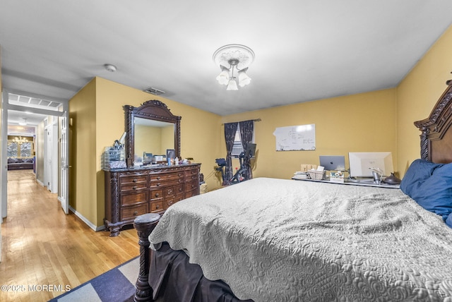 2776 John F Kennedy Blvd, Jersey City, NJ 07306 - bedroom with light wood finished floors, baseboards, visible vents, and a chandelier