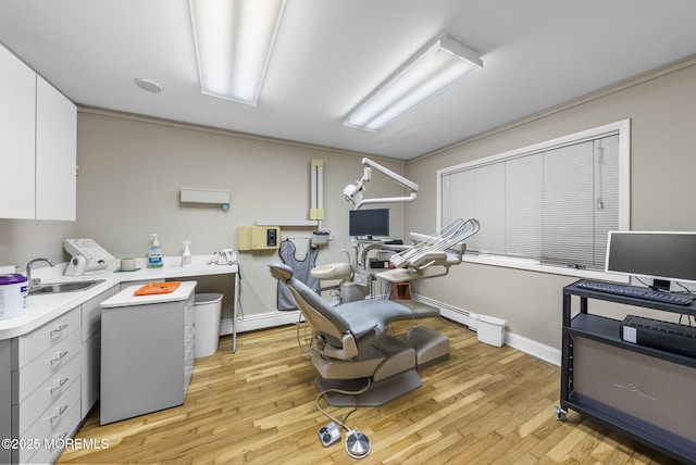 2776 John F Kennedy Blvd, Jersey City, NJ 07306 - washroom featuring a sink, light wood-style flooring, laundry area, baseboards, and a baseboard heating unit
