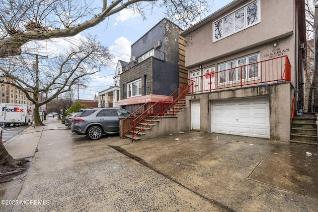 2776 John F Kennedy Blvd, Jersey City, NJ 07306 - view of front facade with driveway, stucco siding, and an attached garage