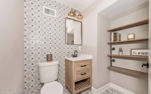 bathroom with visible vents, baseboards, marble finish floor, toilet, and vanity