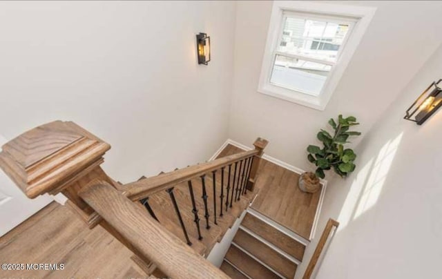 stairs featuring baseboards and wood finished floors