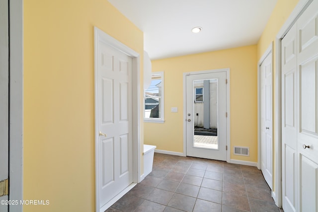 entryway with baseboards and recessed lighting