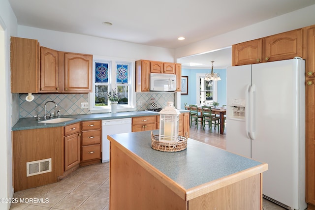 kitchen featuring white appliances, a sink, tasteful backsplash, a chandelier, and recessed lighting