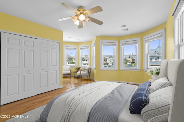 bedroom featuring wood finished floors, a closet, and ceiling fan