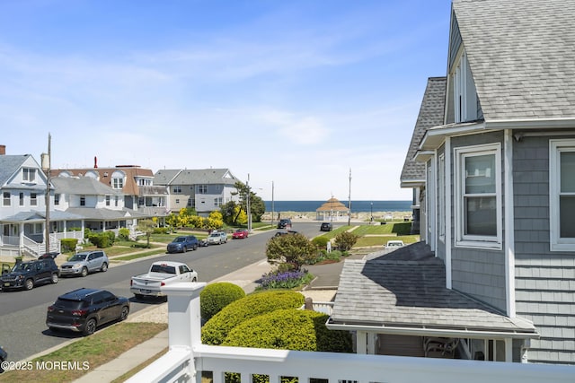 balcony featuring a water view and a residential view