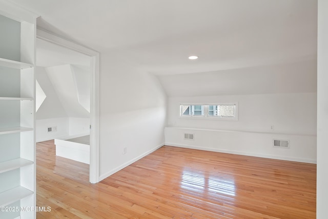 bonus room featuring vaulted ceiling, hardwood / wood-style floors, recessed lighting, and baseboards