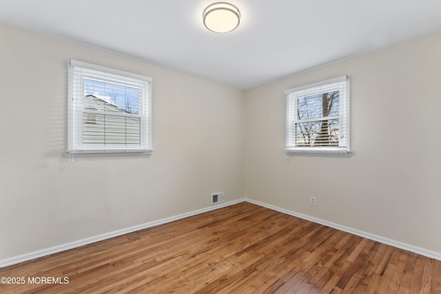 89 Barkalow Ave, Freehold, NJ 07728 - empty room with baseboards, wood-type flooring, and visible vents