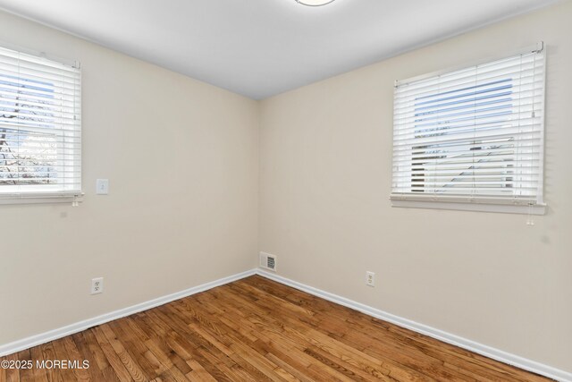 89 Barkalow Ave, Freehold, NJ 07728 - unfurnished room featuring visible vents, baseboards, and wood finished floors
