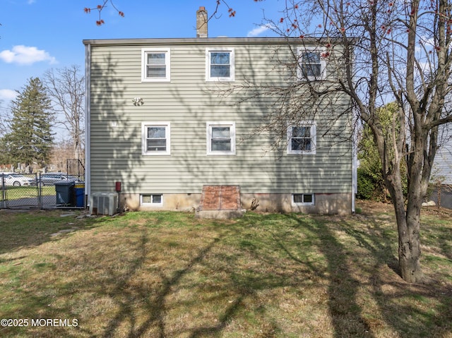 89 Barkalow Ave, Freehold, NJ 07728 - back of property with a chimney, a yard, fence, and central AC