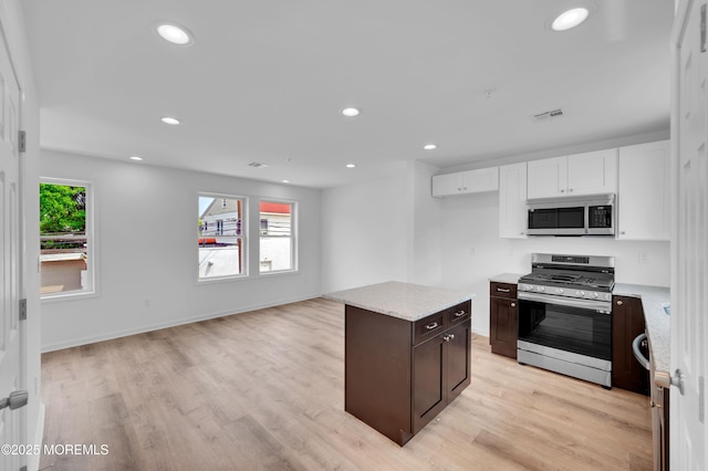 42 W Shore St, Keansburg, NJ 07734 - kitchen featuring appliances with stainless steel finishes, light wood finished floors, white cabinets, dark brown cabinetry, and recessed lighting
