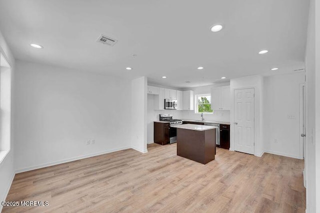 42 W Shore St, Keansburg, NJ 07734 - kitchen featuring appliances with stainless steel finishes, a center island, white cabinetry, recessed lighting, and light countertops
