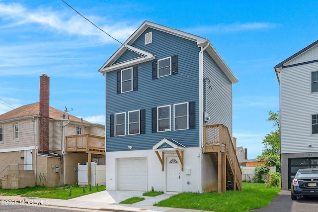 42 W Shore St, Keansburg, NJ 07734 - view of front of home with an attached garage, driveway, stairs, stucco siding, and a deck