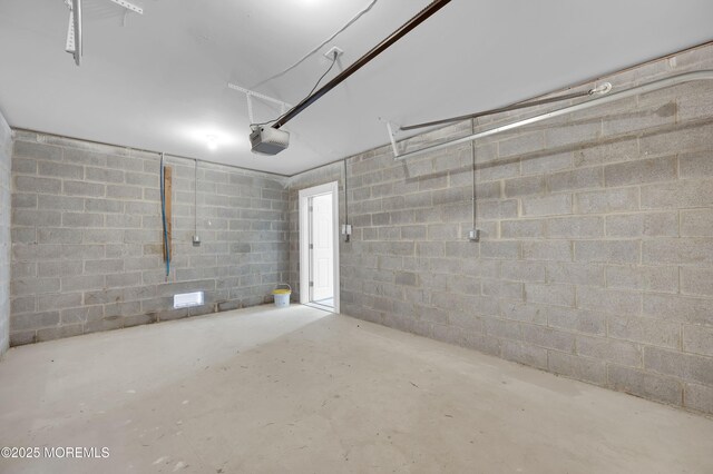 42 W Shore St, Keansburg, NJ 07734 - garage featuring a garage door opener and concrete block wall