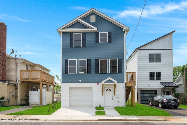 42 W Shore St, Keansburg, NJ 07734 - view of front of property featuring an attached garage, concrete driveway, and stucco siding